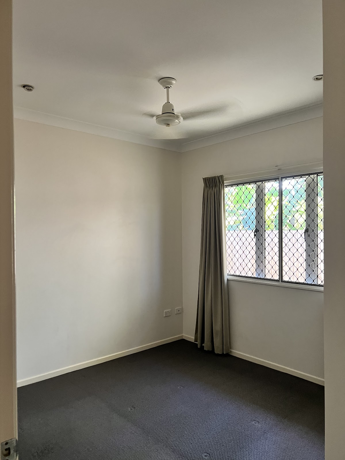 Empty bedroom with freshly steam cleaned carpet after a vacate clean